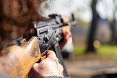 A woman takes aim with an AK-47 Kalashnikov assault rifle