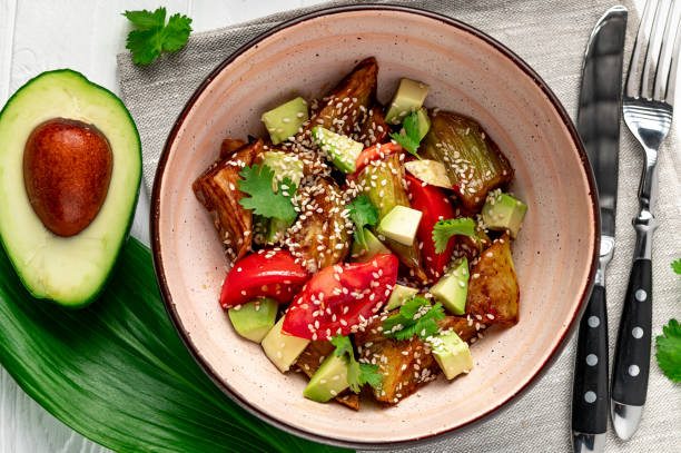 istock Fried eggplant with avocado, tomatoes and sesame seeds. Asian cuisine. 1482014457