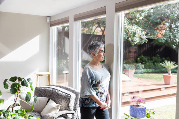 istock Looking out window, senior grandmother has her memories 1482018332