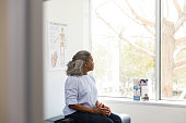 Senior adult woman stares out the window in doctor's office