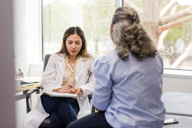 istock Female doctor looks down at her notes and pauses a moment before she answers the patient's question 1482018564