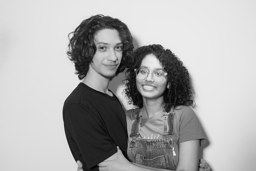 Black and white portrait of young sweethearts isolated on white background.