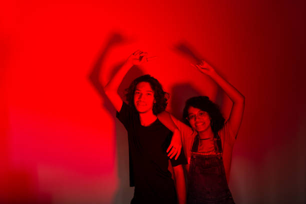 istock Portrait of two young lovers, isolated on background with colored shadows. 1482021089