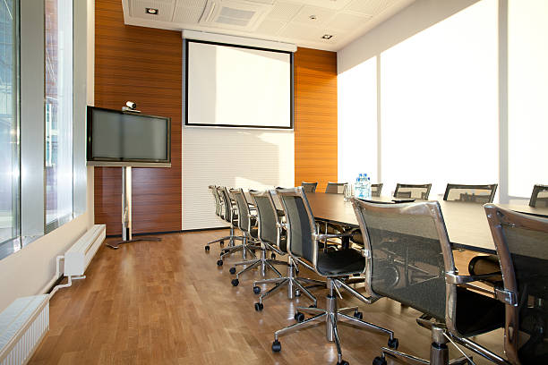 Empty meeting room with TV and projector screen stock photo
