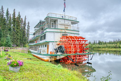 Fairbanks, Alaska - August 27, 2022: Riverboat Discovery III docked at the Chena Village in Fairbanks, Alaska. The stern wheel boat is owned by the Binkley family who run tours along the Chena River.