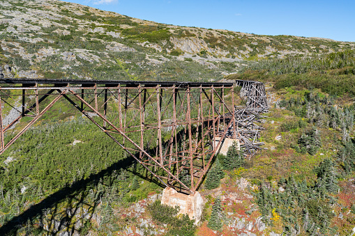 Old abandoned and collapsed railroad bridge along White Pass in Alaska near Skagway