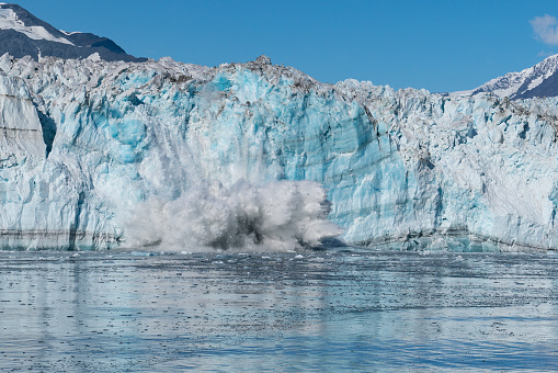 Large piece of ice calving off the face of Hubbard Glacier in Russell Fjord in  Alaska