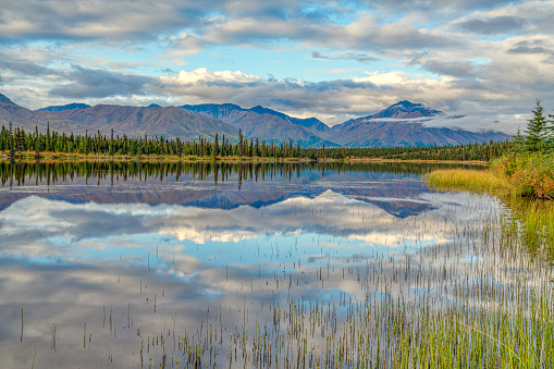 Morning mountain reflection on a lake along the Denali Highway in Alaska