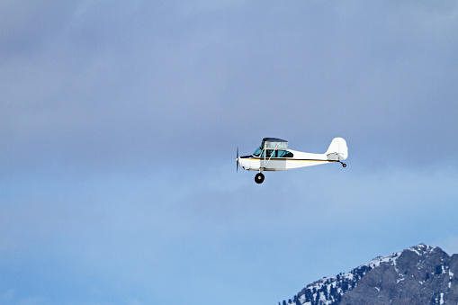 Small private airplane (Aronca 7 AC) inflight over rural Idaho.