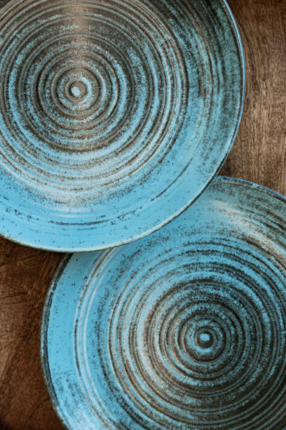 istock Ceramic set of blue empty kitchen plates on a white marble background. Eco and minimal tableware. 1482051017