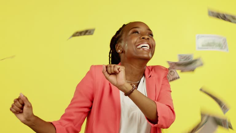 Raining money, dance and happy woman winning lotto award, financial competition prize or cash dollar. Salary, payment or dancing African winner of poker, bingo or casino gambling on yellow background