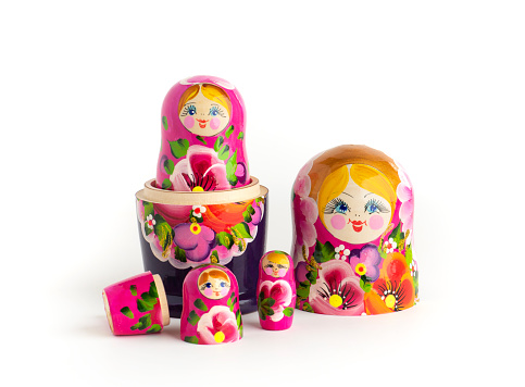 Russian Matryoshka Dolls in different sizes. Traditional Matryoshka set in a row. Set of wooden toys on white background.