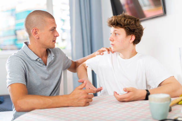 istock Dad and teenager son having conversation 1482059235