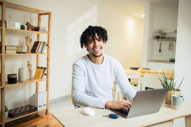 istock Happy young man is working on a laptop 1482059822