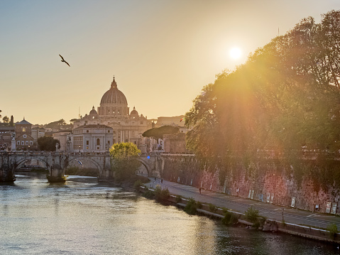 The historic city of Rome in Italy on April  17, 2022:   St. Peter's Basilica and the Vatican seen by the Tiber River in  Rome Italy