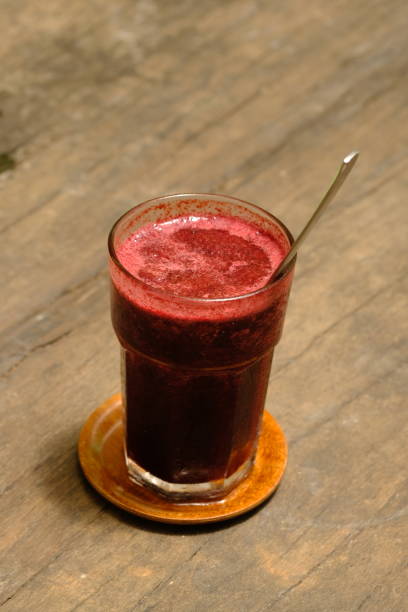 istock Mulberry Juice in a Glass on Wooden Table 1482063530