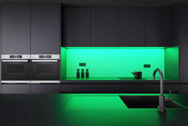 istock Black Modern minimalist kitchen with long island with stools. Dark materials. LED green lights 1482063626
