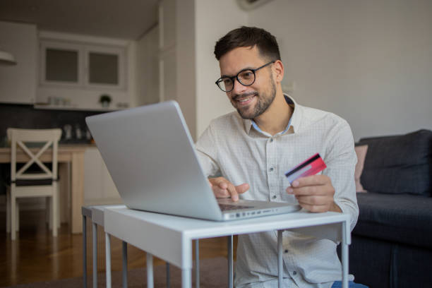 istock Man using her credit card to shop online 1482071540