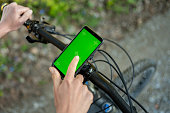 Person using smartphone attached to bicycle