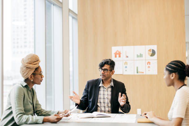 istock Male financial advisor in discussion with client in office conference room 1482072424