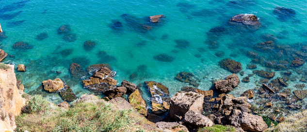 A rocky beach with clear turquoise water in the west of Sicily. Aerial view.