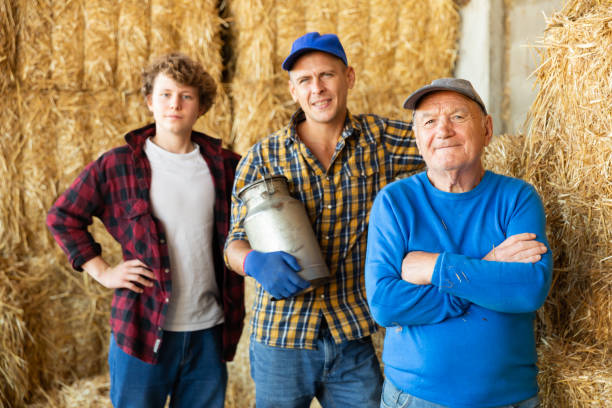 istock Various aged farmers standing inside hay bales storage 1482083108