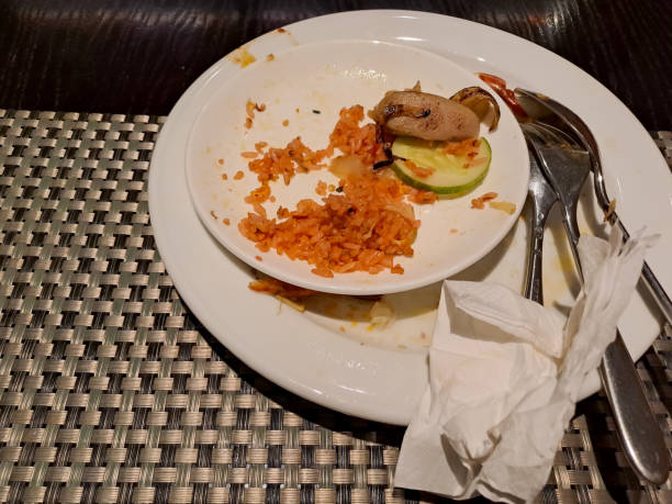 istock Empty dirty plate with dish leftovers and metal utensils placed on table in restaurant 1482091262