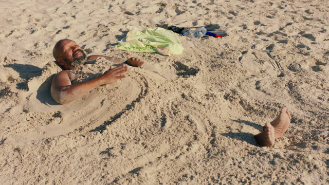 funny man covered in sand on beach enjoying summertime having fun relaxing on warm sunny day 4k
