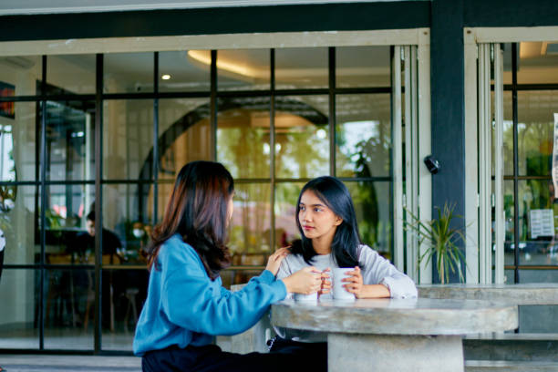 istock Two asian young woman having conversation together 1482121097