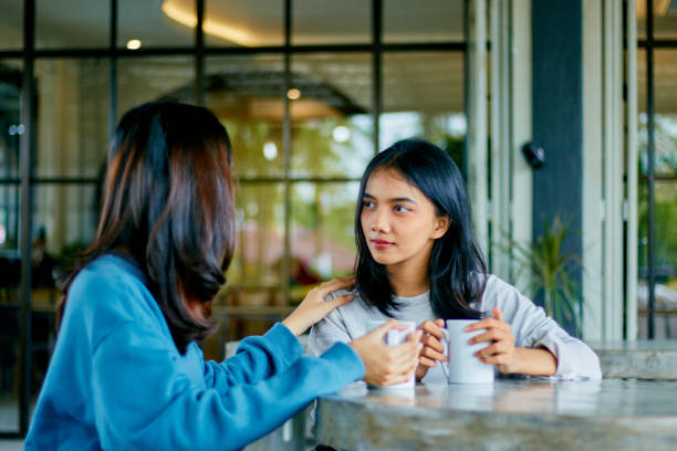 istock Two asian young woman having conversation together 1482121098
