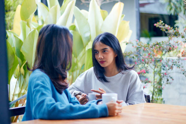 istock Asian female having deep conversation at cafe 1482121102