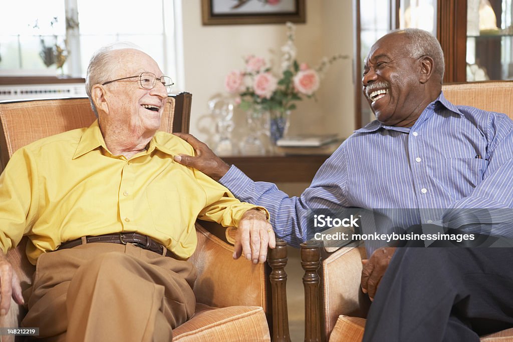 Senior men relaxing in armchairs Senior men relaxing in armchairs and laughing together Senior Adult Stock Photo