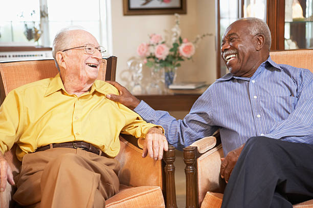 Senior men relaxing in armchairs Senior men relaxing in armchairs and laughing together 80 89 years stock pictures, royalty-free photos & images