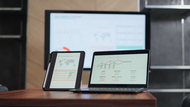 Close up of laptop, digital tablet and TV monitor showing chart and graph of data analytic dashboard. Infographic dashboard template with modern design. Business and statistics concept.