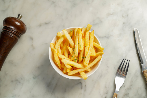 French fries bucket served in dish isolated on marble background top view on hong kong food