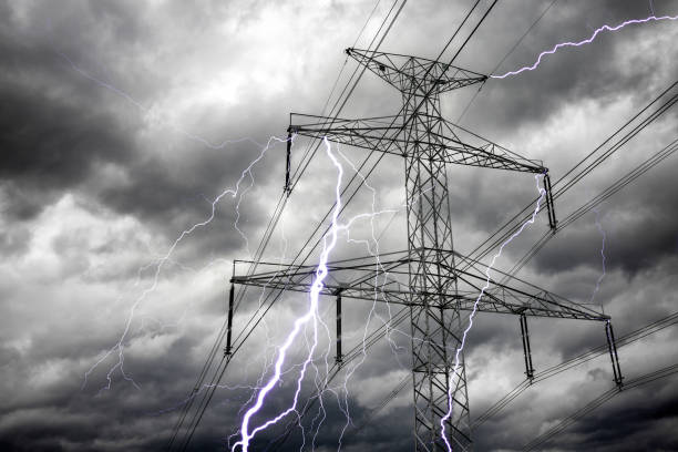 istock Bright lightning bolts from electric power pylon tower.  Electricity discharge clouds 1482126414