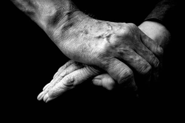 istock Elderly couple holding hands together 1482127211