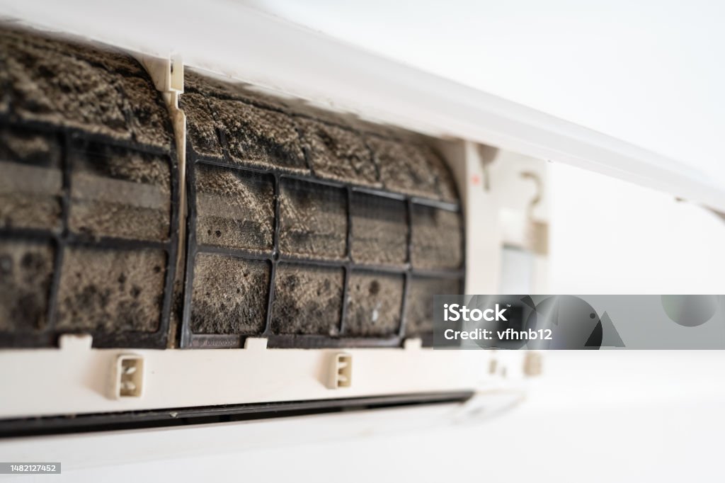Dirty in dust and mold air conditioner filter close-up. Home air conditioner maintenance. Air Conditioner Stock Photo