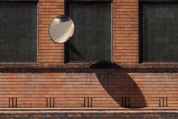 Vintage circle wooden window on a brick wall building. Architectural design with lines and circle