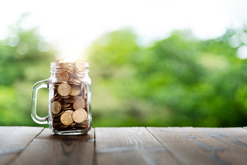 istock Glass jar full of coins 1482128577