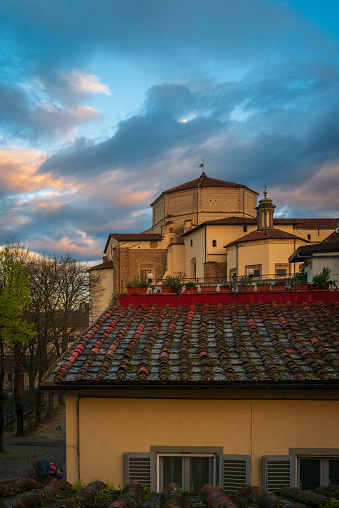 Firenze town skyline with houses and church at sunrise in the Metropolitan City of Florence, Tuscany Region, Italy, a rooftop view through the window