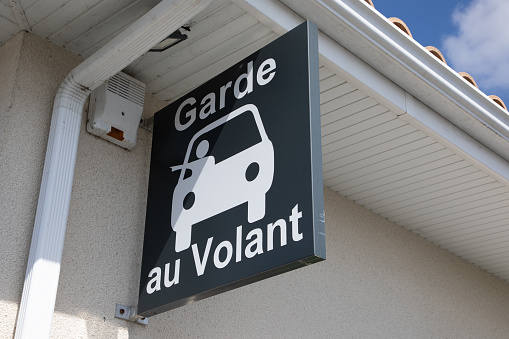 garde au volant sign car and french text means all-night drugstore in drive thru service