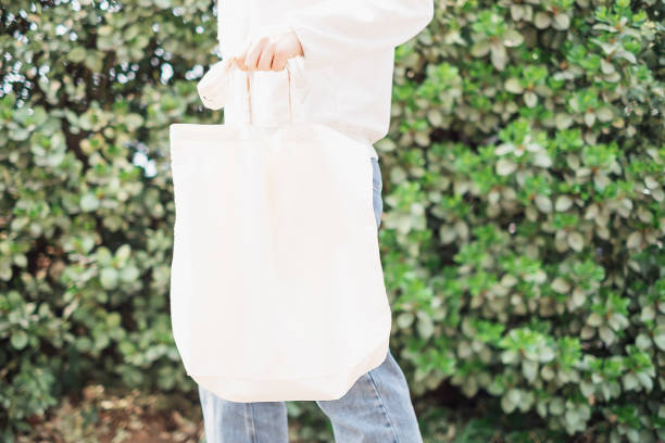 istock Female hand holding rag bag against a green wall. 1482129341