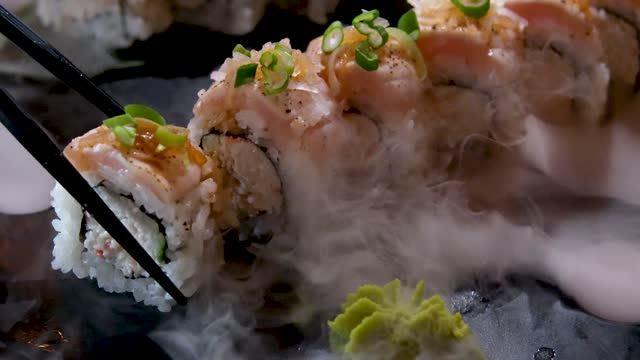 delicious restaurant asian food sushi on plate with dry ice eel tuna set enveloping all around space for text advertising sushi serving menu chef courses sushi maker close-up incredibly delicious