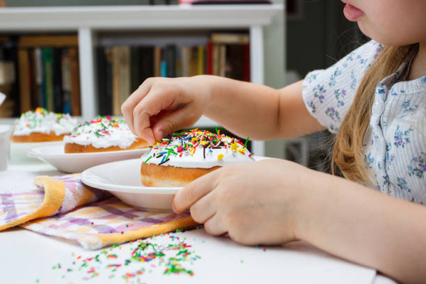 istock Process of decorating a cake with sweet colored decorations, concept of cooking 1482137581