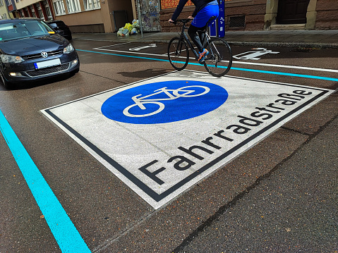 stuttgart, bw, germany - april 14, 2023 Indication of a road for bike lane with cyclist and car