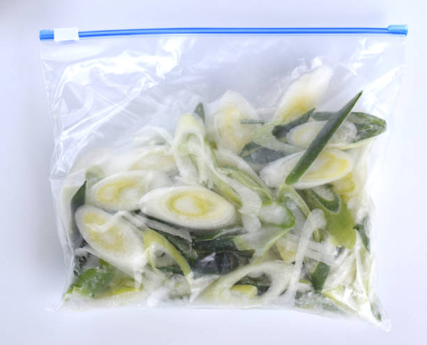 istock frozen green onion on the table. 1482141757