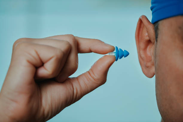 istock swimmer man about to put an earplug 1482142577