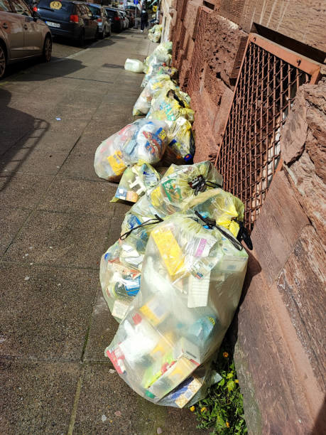 garbage bags on a sidewalk in the city stock photo