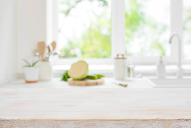 istock Wooden cooking table top on blurred kitchen window light background 1482144377
